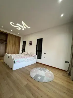 a bedroom with a bed and a wooden floor at Elite Villa on the Road to Fes in Marrakech
