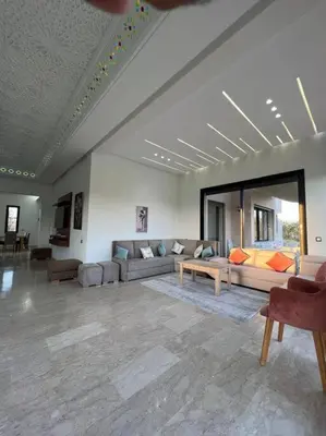a large living room with couches and a table at Elite Villa on the Road to Fes in Marrakech