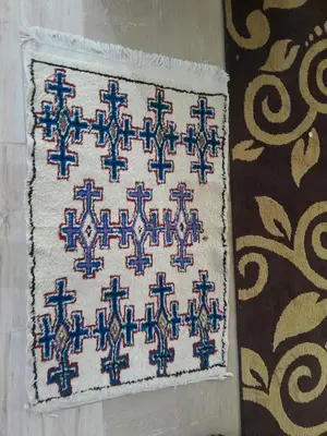 a blue and white rug with a pattern on it at dar hanane in Zaouia Sidi Rahkal