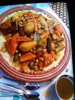 a plate of food with beans and vegetables on rice at dar hanane in Zaouia Sidi Rahkal