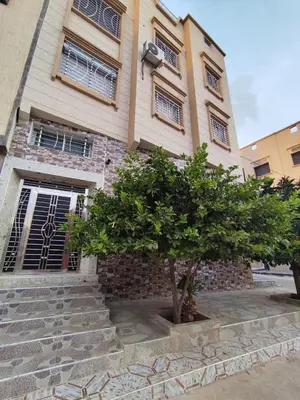 a building with a tree in front of it at Modern suite BJ in Boujad
