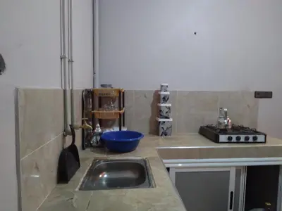 a kitchen with a sink and a counter top at Appartement Chez issmail in Tinerhir