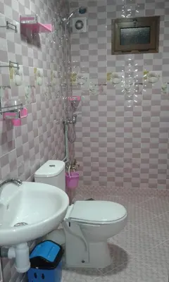 a bathroom with a toilet and a sink and a shower at Hôtel La Vallée Des Oiseaux in Boumalne