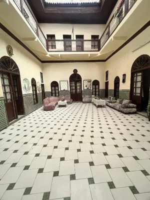 an empty lobby with a large room with couches at HOTEL DU PARq in Fès