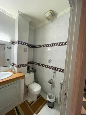 a bathroom with a toilet and a sink at chamber chez l habitant pour les femmes à côté CTM & Gare du train in Fès