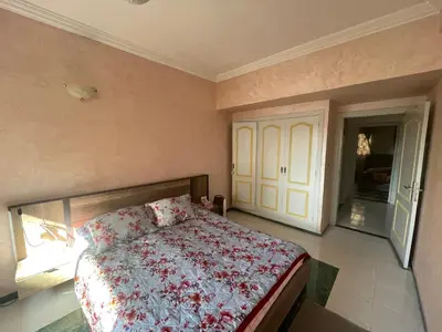 a bedroom with a bed with a floral bedspread at chamber chez l habitant pour les femmes à côté CTM & Gare du train in Fès