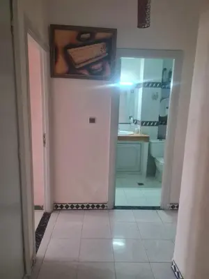 a bathroom with a sink and a toilet and a mirror at chamber chez l habitant pour les femmes à côté CTM & Gare du train in Fès
