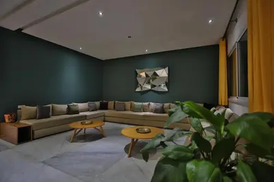 a living room with a couch and two tables at Villa familiale moderne avec piscine in Fès