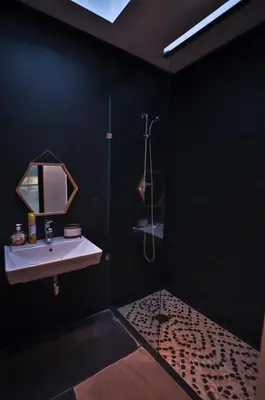 a black bathroom with a sink and a shower at Villa familiale moderne avec piscine in Fès