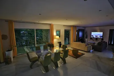a living room with a glass table and a couch at Villa familiale moderne avec piscine in Fès
