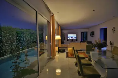 a living room with a dining table and a living room at Villa familiale moderne avec piscine in Fès