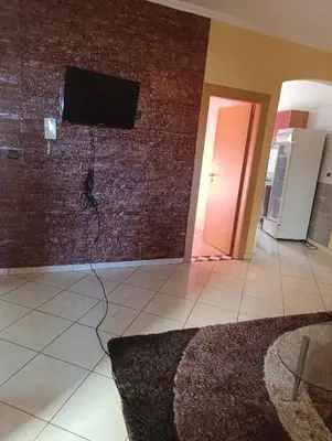 a living room with a television on a brick wall at Ramz Appartement in Beni Mellal