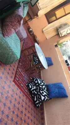 an overhead view of pillows on the floor in a room at House andalous in Fès