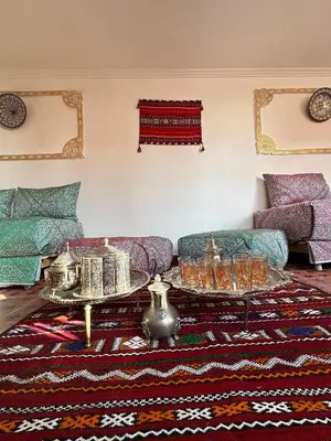 a living room with a couch and a table at House andalous in Fès