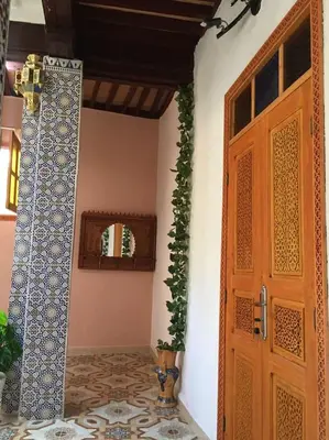 a room with a door and a potted plant at House andalous in Fès