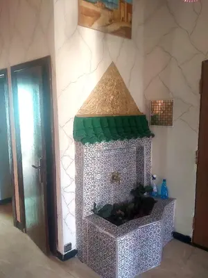 a fish tank in the corner of a room at Air house in Gare de Meknès