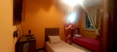 a small bedroom with a bed and a window at Air house in Gare de Meknès
