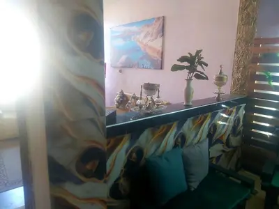 a living room with a table and a couch at Air house in Gare de Meknès