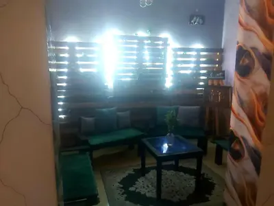 a living room with a couch and a table at Air house in Gare de Meknès