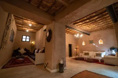 a large living room with a bed and a couch at Dar Kamar in Ouarzazate