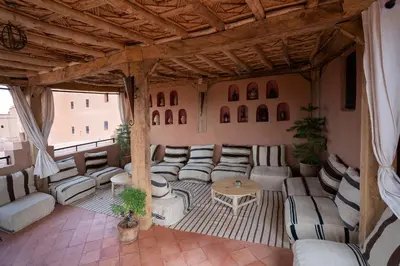 a large living room with couches and a table at Dar Kamar in Ouarzazate