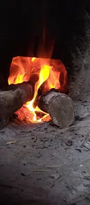 a fire is coming out of a brick oven at Ryad-IGRANE in Ouarzazate