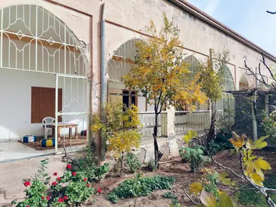 a building with a garden in front of it at Ryad-IGRANE in Ouarzazate