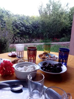 a table with plates of food and glasses on it at Ryad-IGRANE in Ouarzazate
