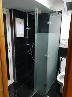 a bathroom with a glass shower with a toilet at Welcome1 in Meknès