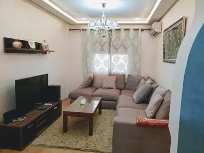 a living room with a couch and a tv at Welcome1 in Meknès