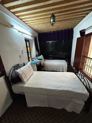 a bedroom with two beds in a room at DarMouniaFès in Fès