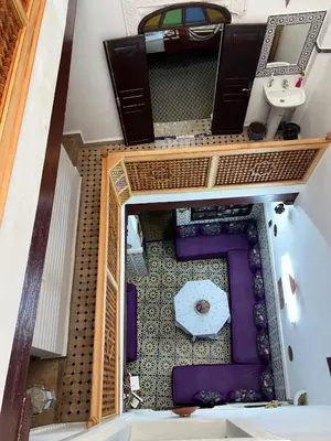 an overhead view of a room with a table and an umbrella at DarMouniaFès in Fès
