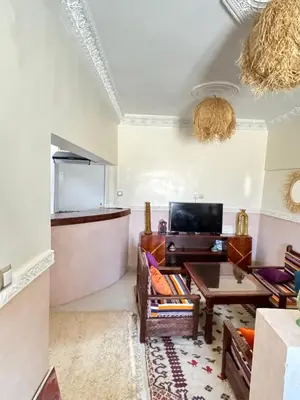 a living room with a couch and a table at Apparemment de luxe avec terrasse privée in Zagora