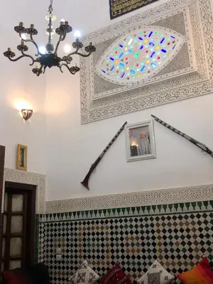 a room with a ceiling with a chandelier at Dar Lalla Wafae in Fès