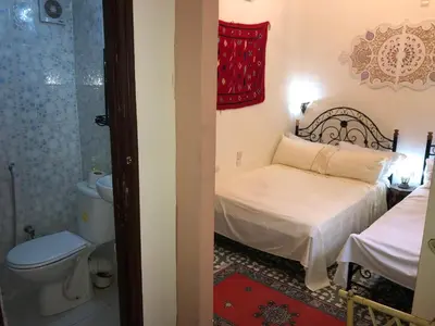 a small bedroom with a bed and a toilet at Dar Lalla Wafae in Fès