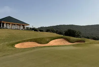 a golf course with a bunker on a green at Scandinavian Chalet in the Atlas Mountains - Ifrane in Ifrane
