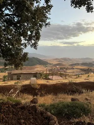 a view of a field with a building in the distance at Scandinavian Chalet in the Atlas Mountains - Ifrane in Ifrane