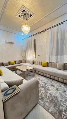 a living room with couches and a chandelier at Rout ourika in Marrakech
