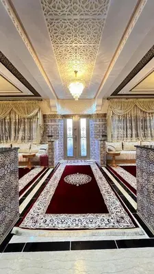 a large room with a large red rug on the floor at Rout ourika in Marrakech