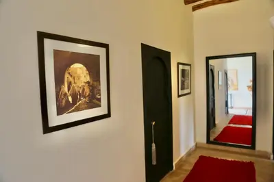 a hallway with a painting on the wall and a door at Villa Beldi Chic Novari avec piscine chauffée - 8 personnes - Marrakech - Petit déjeuner inclus in Douarbel Kial