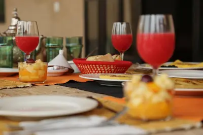 a table topped with plates of food and wine glasses at Villa Beldi Chic Novari avec piscine chauffée - 8 personnes - Marrakech - Petit déjeuner inclus in Douarbel Kial
