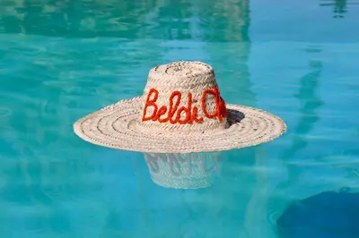 a straw hat is sitting in the water at Villa Beldi Chic Novari avec piscine chauffée - 8 personnes - Marrakech - Petit déjeuner inclus in Douarbel Kial