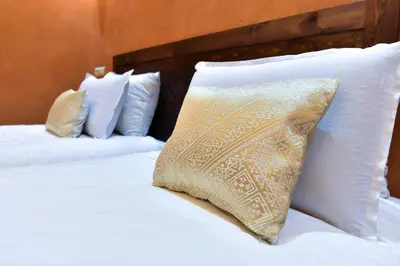 two white beds with a pillow on top of them at Dar Chams Ouarzazate in Ouarzazate