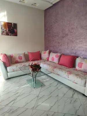 a living room with a couch and a glass table at Chez Adam in Meknès