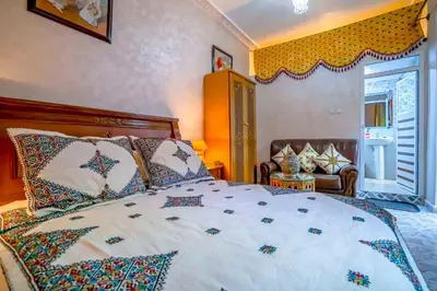 a bedroom with a large bed with colorful pillows at Dar Lmrama - Entire House in Fes in Fès