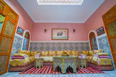 a living room with a couch and a table at Dar Lmrama - Entire House in Fes in Fès