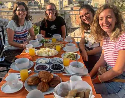 a group of women sitting around a table with food at Dar Lmrama - Entire House in Fes in Fès
