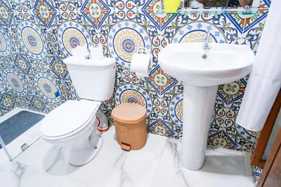 a bathroom with a toilet and a sink at Dar Lmrama - Entire House in Fes in Fès