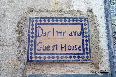 a sign on a wall that says dance me and guest house at Dar Lmrama - Entire House in Fes in Fès