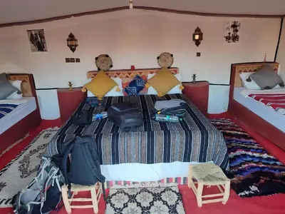 a bedroom with two beds with luggage on it at Luxury Desert Camp Erg Chegaga in El Gouera